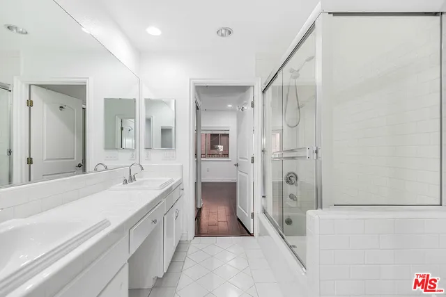 an empty room with wooden floor and window