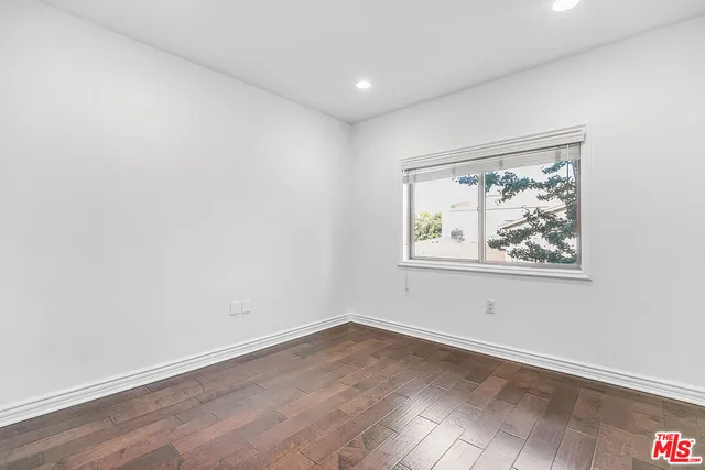 a spacious bathroom with a tub sink and mirror