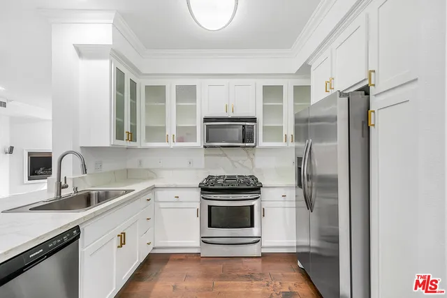 a kitchen with a refrigerator stove and sink