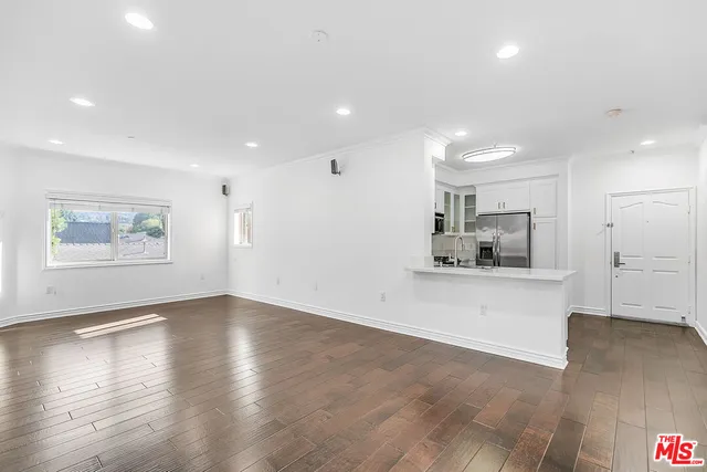 a view of kitchen with stainless steel appliances a refrigerator and a stove top oven