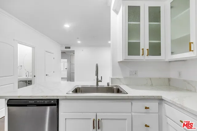 a kitchen with a sink and cabinets