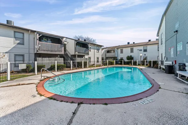 a view of a house with swimming pool and porch