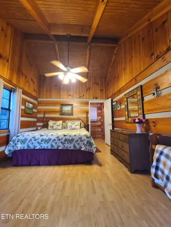 a bed sitting in a bedroom next to a window