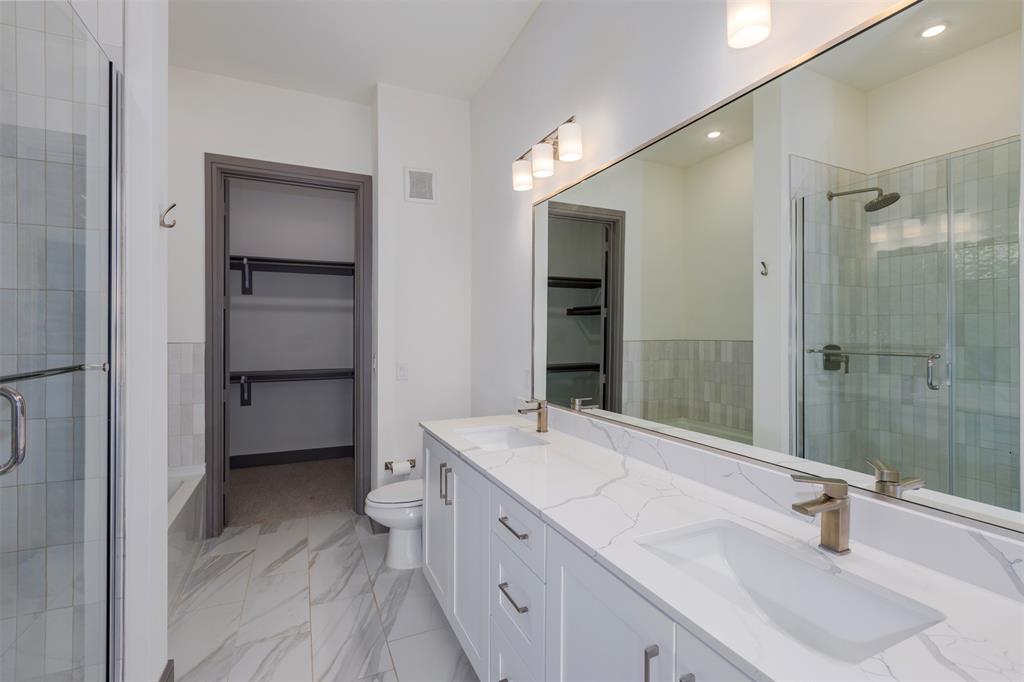 2700 Old Denton Road, Unit 1044 Carrollton, TX 75007 - Photo 11 of 33 Dual vanity with white cabinetry and quartz countertops