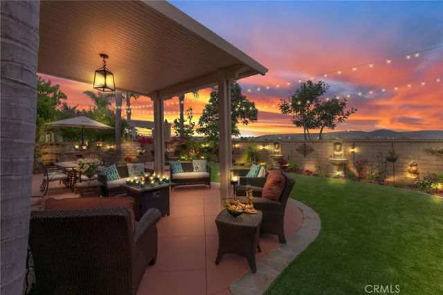 a view of a patio with couches and table and chairs and garden