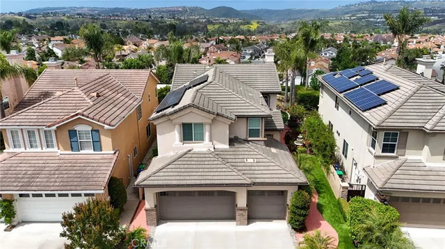 an aerial view of a house with a yard