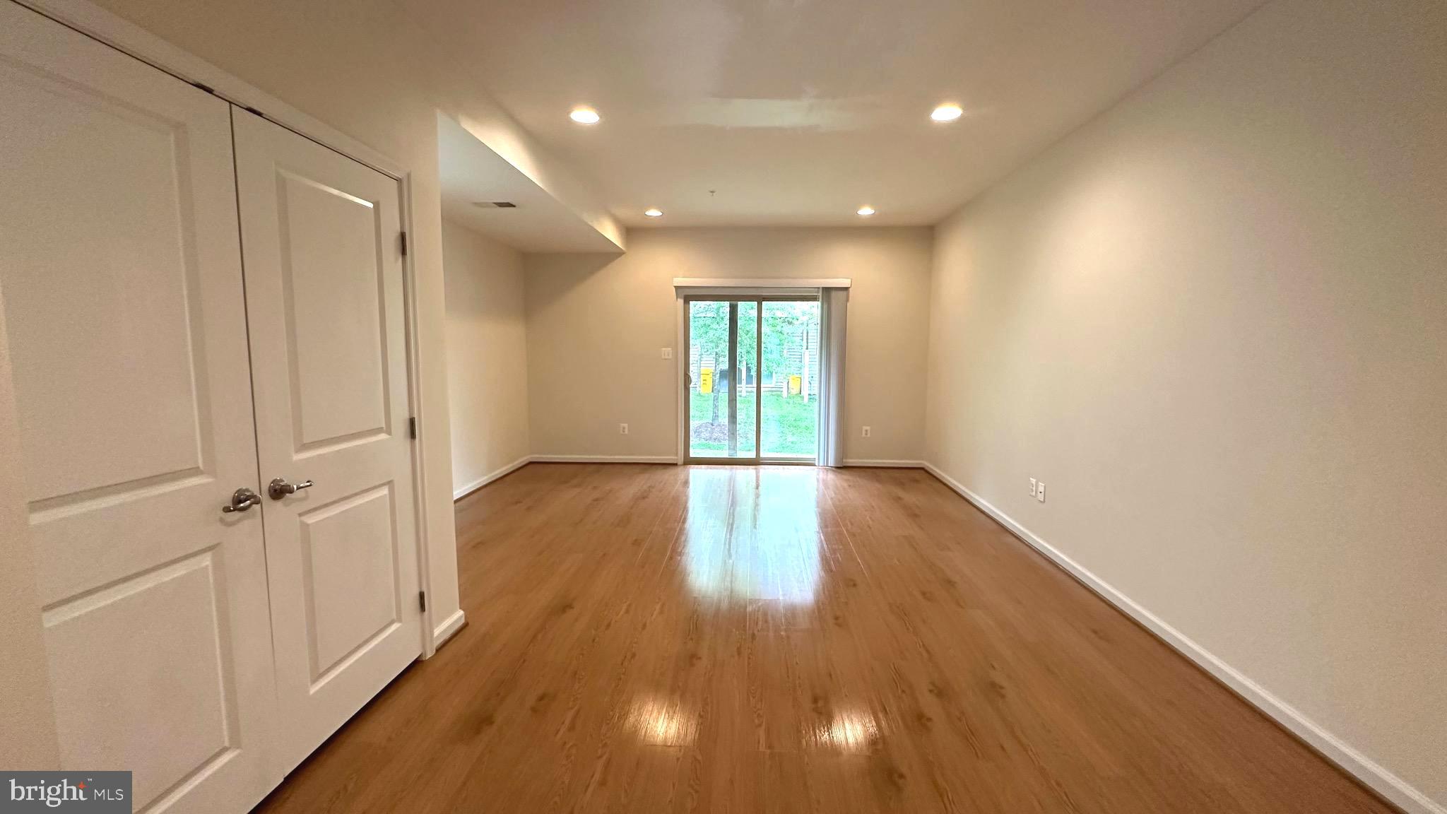 7343 Old Calvary Road Hanover, MD 21076 - Photo 9 of 35 a view of an empty room with wooden floor and a window