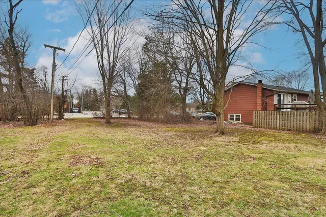 a backyard of house with large trees