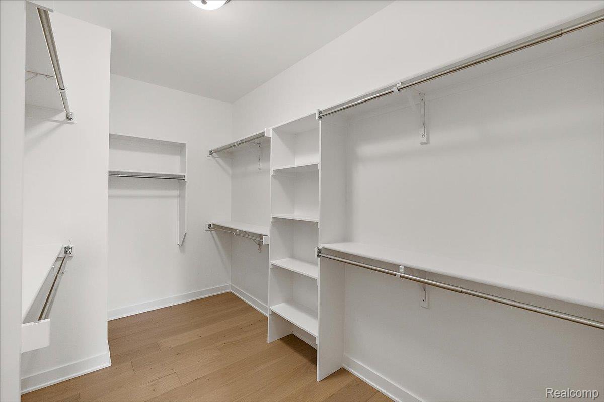 2032 Breckenridge Court, Unit 9 Rochester, MI 48309 - Photo 22 of 39 Walk in closet featuring light wood-style flooring