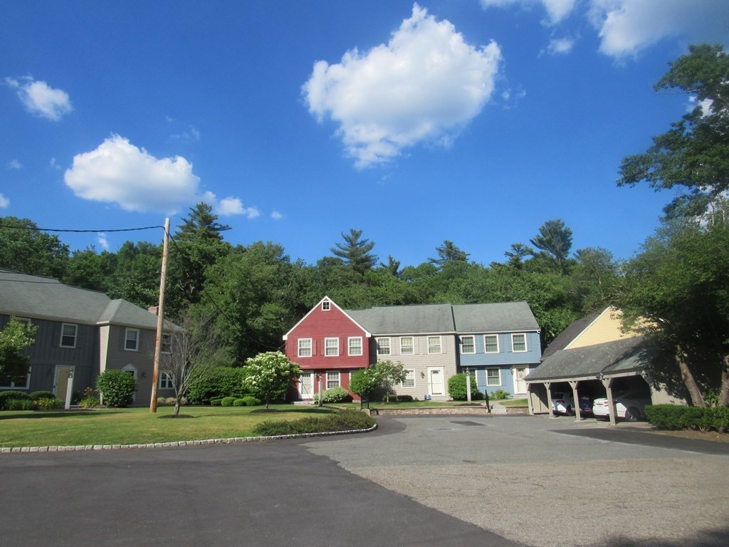104 King George Drive Boxford, MA 01921 - Photo 12 of 12 a front view of a house with a yard and trees