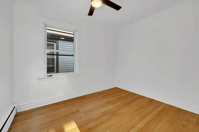 a view of empty room with ceiling fan