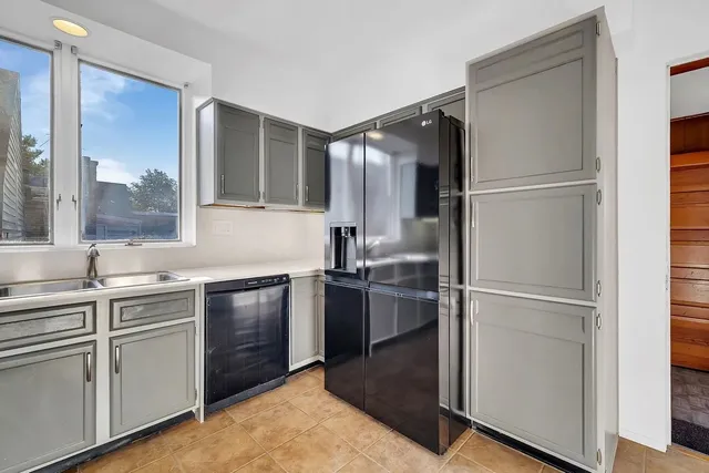a kitchen with a refrigerator and a sink