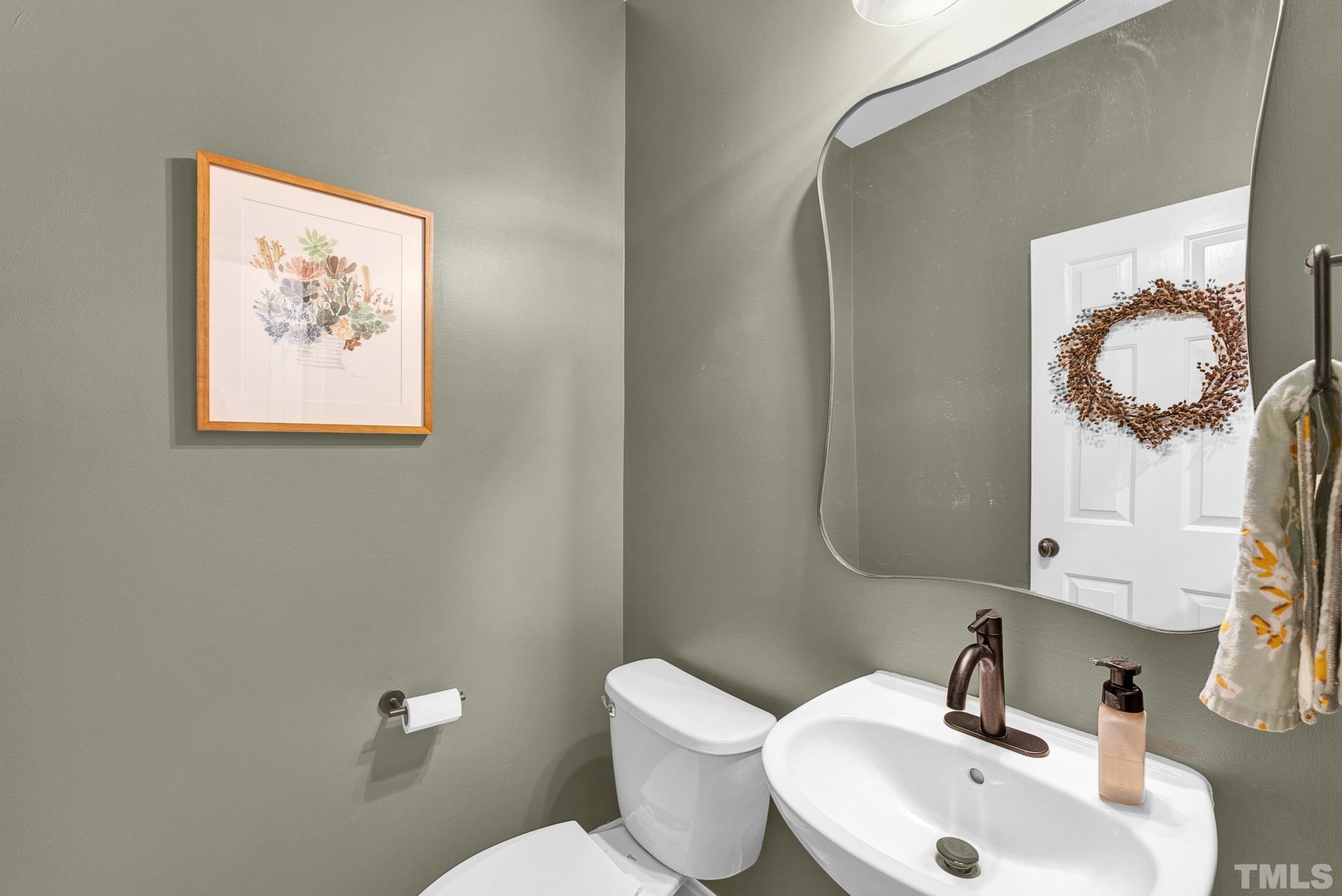 161 Ryder Cup Circle Raleigh, NC 27603 - Photo 11 of 31 a bathroom with a toilet sink and mirror