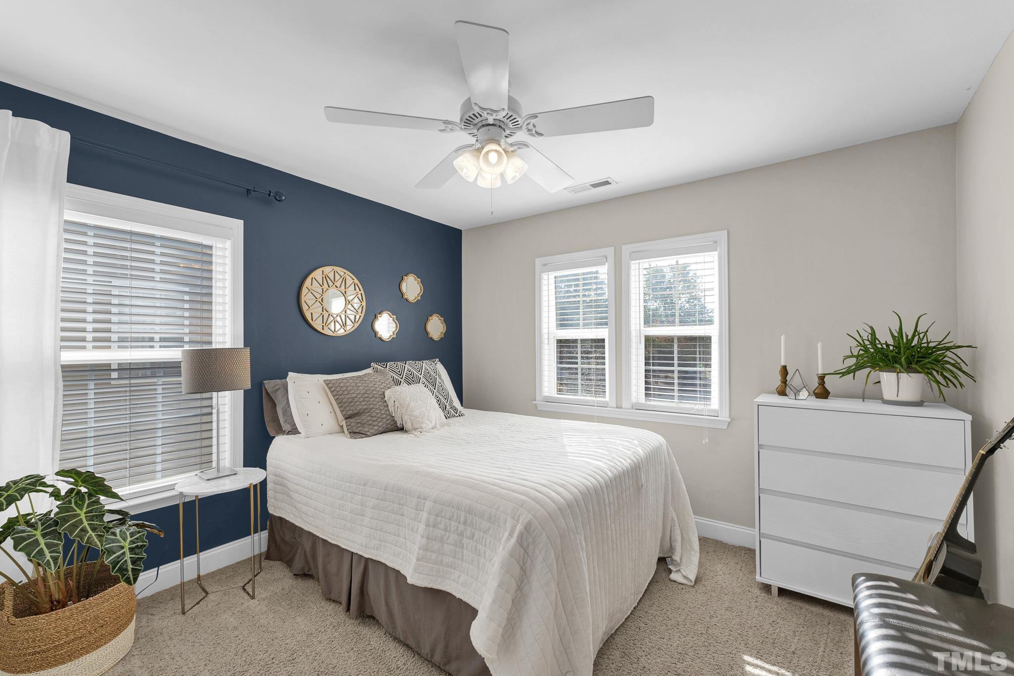 161 Ryder Cup Circle Raleigh, NC 27603 - Photo 20 of 31 a bedroom with a large bed and a window