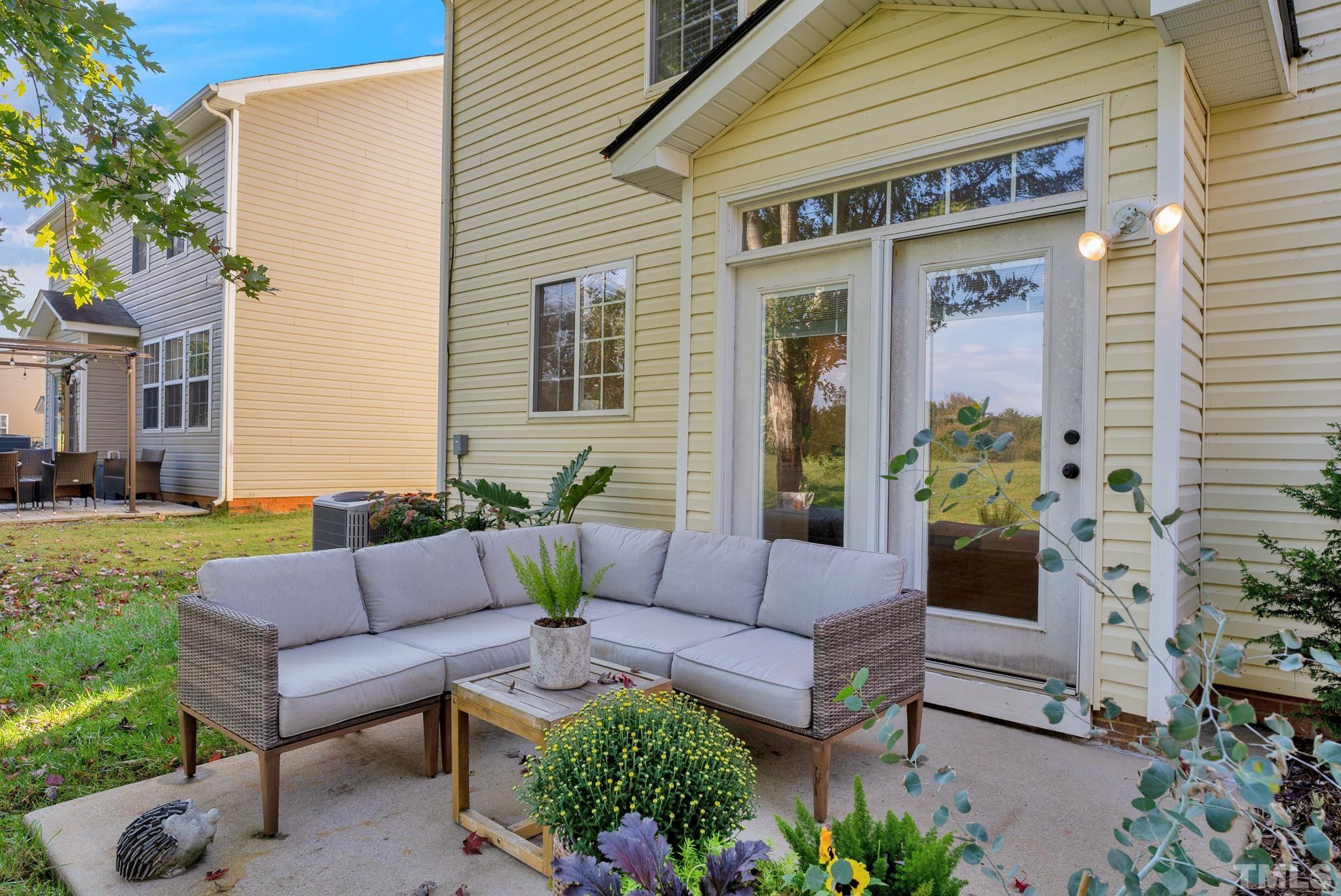 161 Ryder Cup Circle Raleigh, NC 27603 - Photo 23 of 31 a view of a patio with couches table and chairs and potted plants