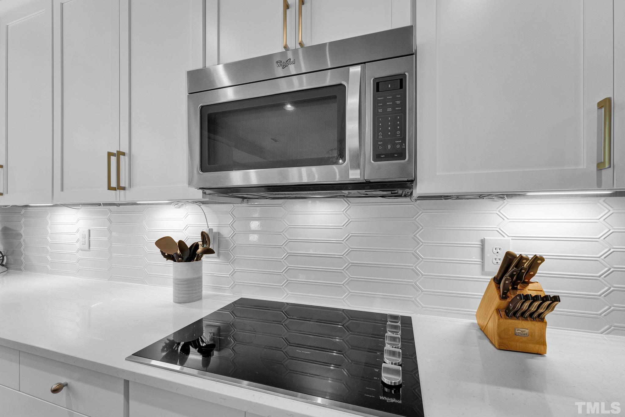 161 Ryder Cup Circle Raleigh, NC 27603 - Photo 6 of 31 a kitchen with a stove and a microwave
