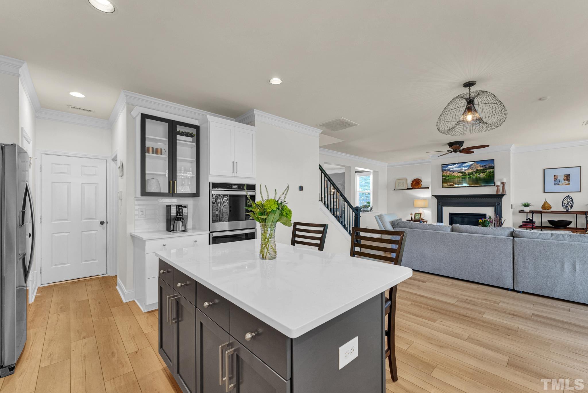 161 Ryder Cup Circle Raleigh, NC 27603 - Photo 7 of 31 a kitchen with stainless steel appliances kitchen island hardwood floor and center island
