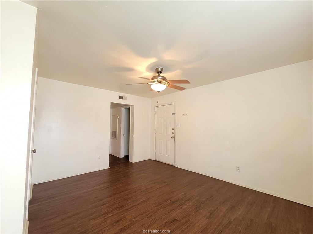 2712 Evergreen Circle Bryan, TX 77801 - Photo 26 of 30 Unfurnished room with dark hardwood / wood-style flooring and ceiling fan