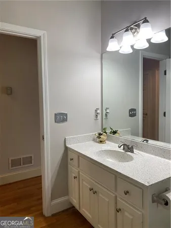 a bathroom with a sink vanity and a mirror