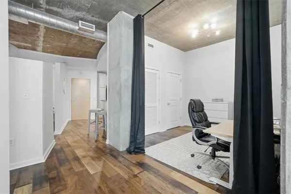 a view of a hallway to a livingroom and a bathroom with sink