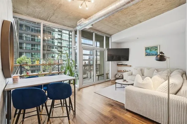a living room with furniture and a flat screen tv