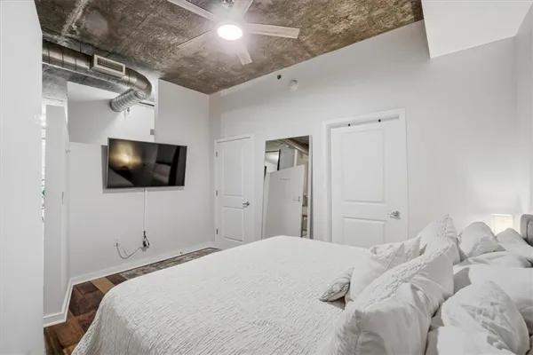 a bedroom with a bed and a flat screen tv