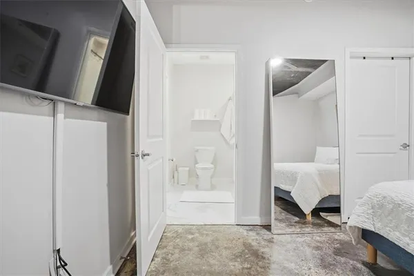 a bedroom with a bed and a mirror