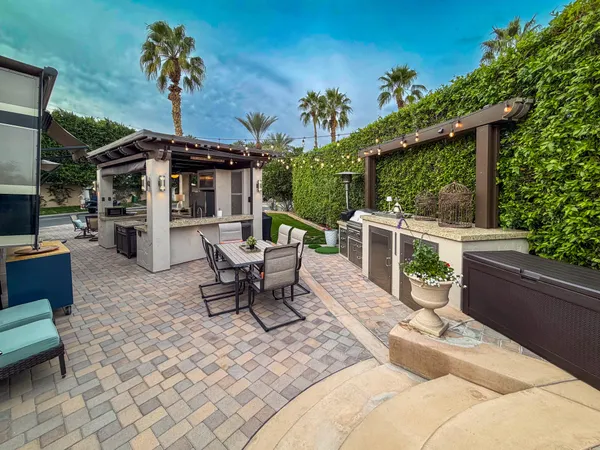 a view of a patio with a dining table and chairs