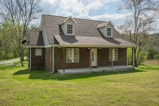 a view of a house with garden and yard