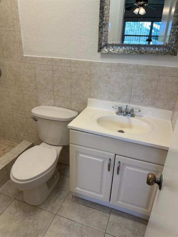 7831 North Colony Circle, Unit 203 Tamarac, FL 33321 - Photo 9 of 13 a bathroom with a toilet and a sink