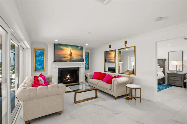 a living room with furniture fireplace and a large window