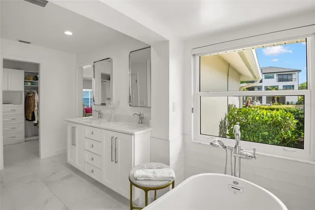 a white bath tub sitting next to a white toilet