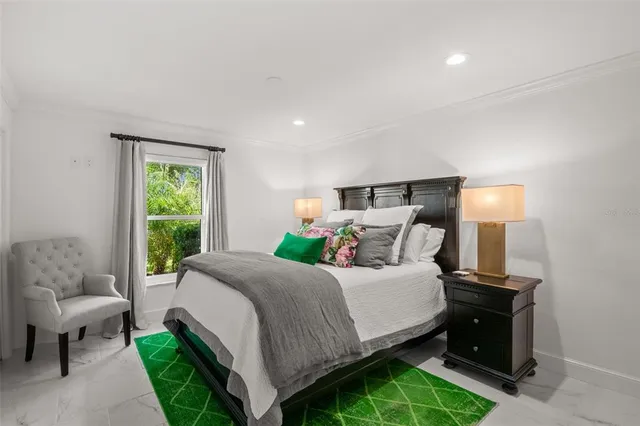 a bedroom with bed and a window