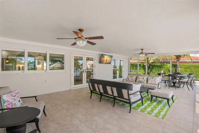 a living room with furniture and large windows