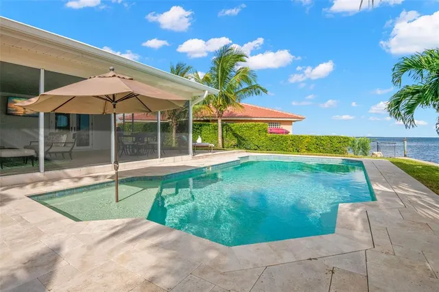 a swimming pool with outdoor seating and yard