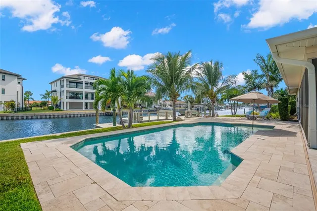 a view of a patio with table and chairs with wooden floor and fence