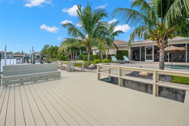 a view of a house with a yard and palm trees