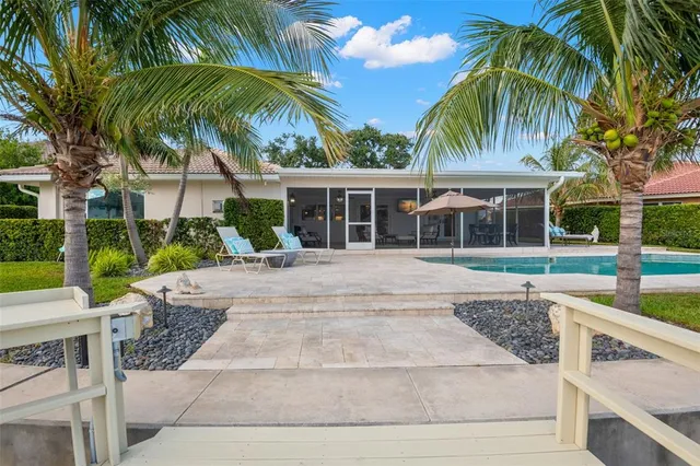 a view of a lake with a big yard and large trees
