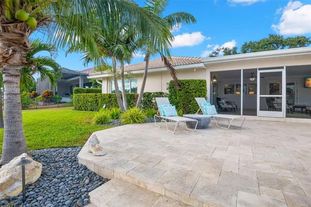 a view of a patio with table and chairs with wooden floor and fence