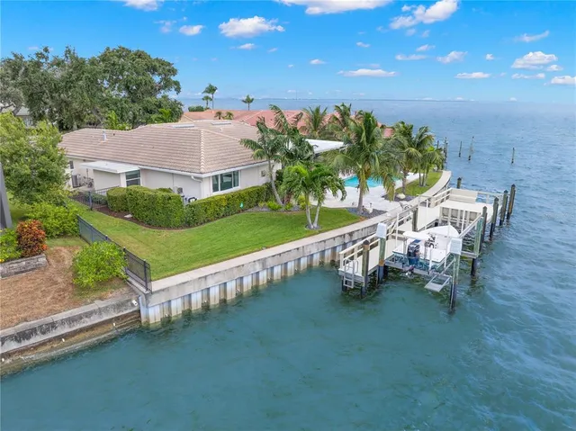 a front view of a house with a yard garage and outdoor seating