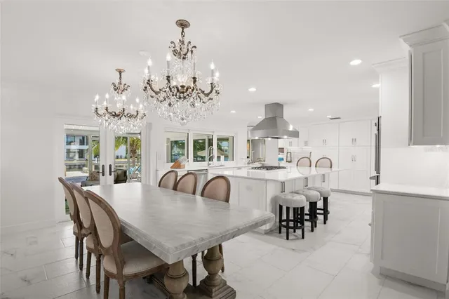 a view of a dining room with furniture a rug and wooden floor