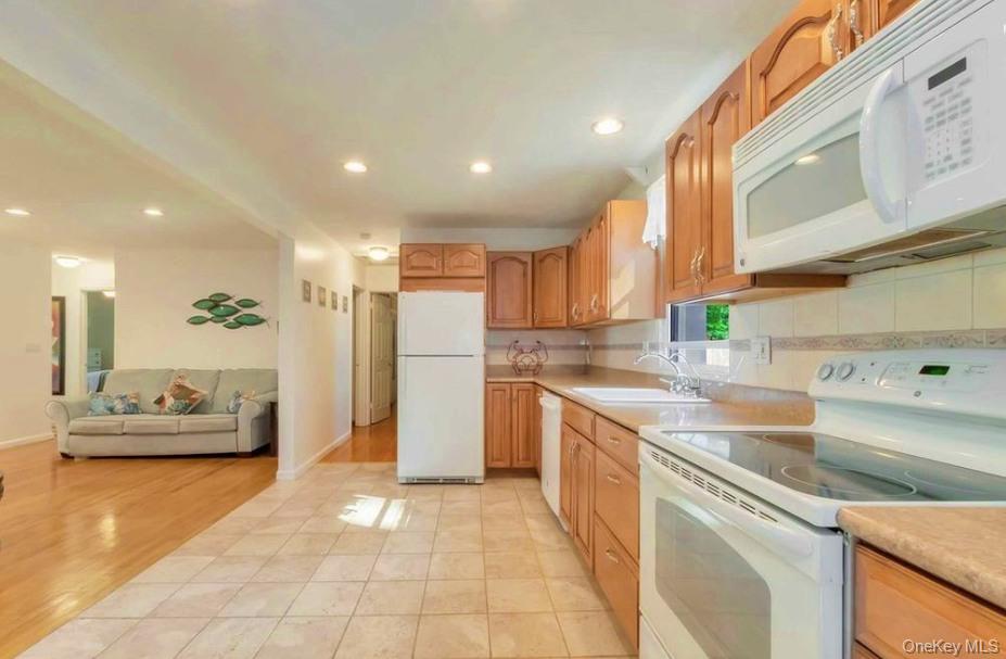 430 Grove Road Southold, NY 11971 - Photo 5 of 15 a kitchen with a sink a refrigerator and a stove top oven
