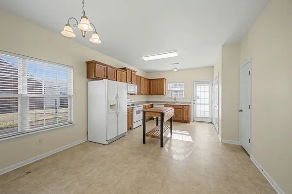 a view of kitchen with dining table and chairs