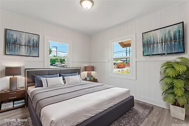 a bedroom with a bed and a painting on the wall