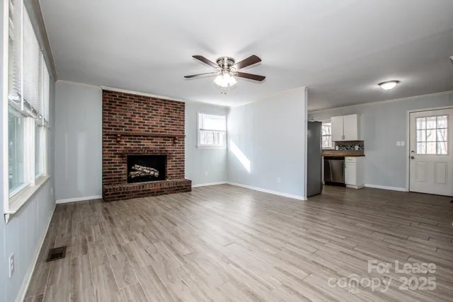 a view of an empty room with wooden floor