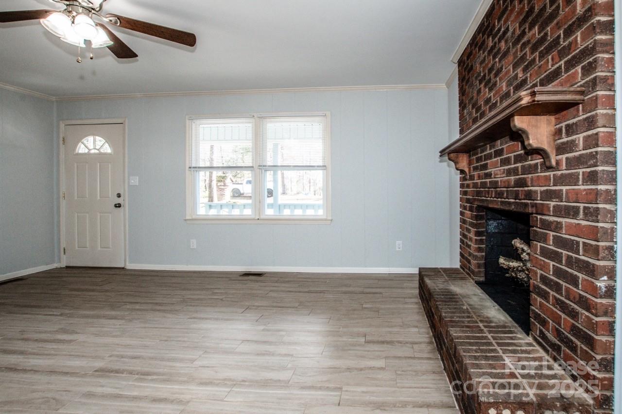 1159 Camp Creek Road Iron Station, NC 28080 - Photo 15 of 48 wooden floor in an empty room with a window