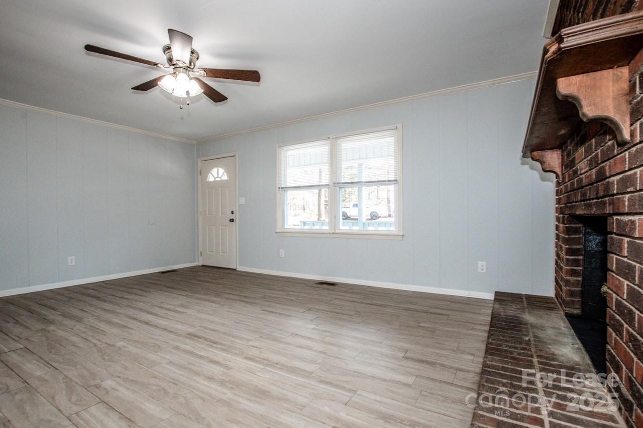 1159 Camp Creek Road Iron Station, NC 28080 - Photo 17 of 48 wooden floor in an empty room with a window
