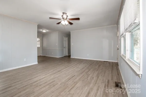 a kitchen with wooden floors and white appliances