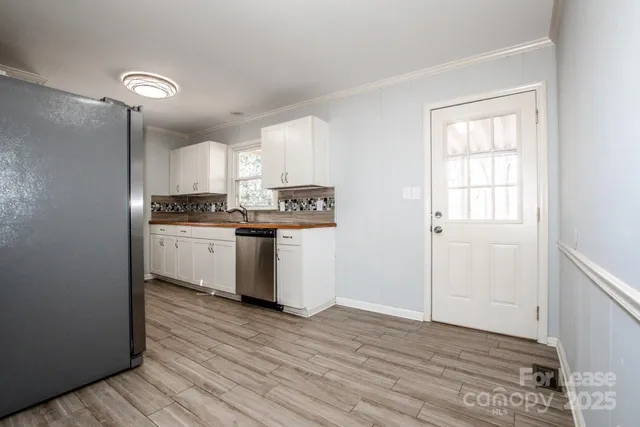 a view of a room with wooden floor