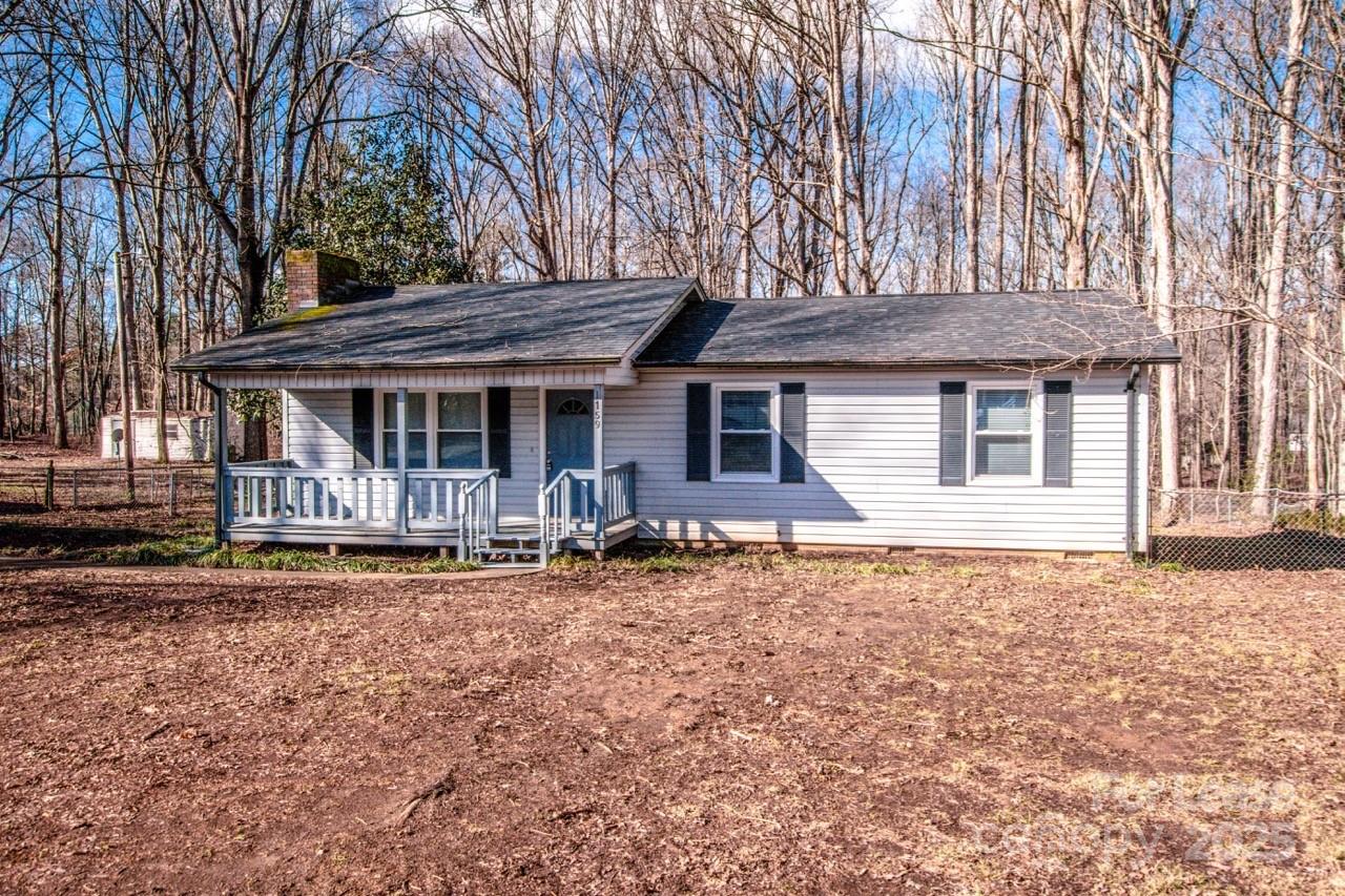 1159 Camp Creek Road Iron Station, NC 28080 - Photo 2 of 48 a front view of a house with garden